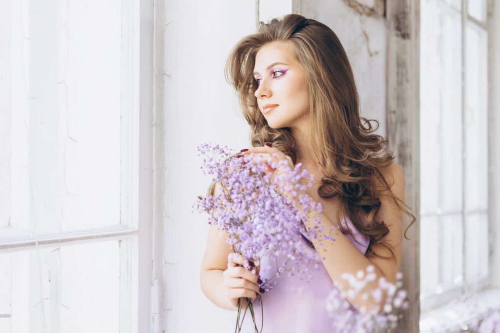 Beautiful sexy female model in lilac delicate dress.